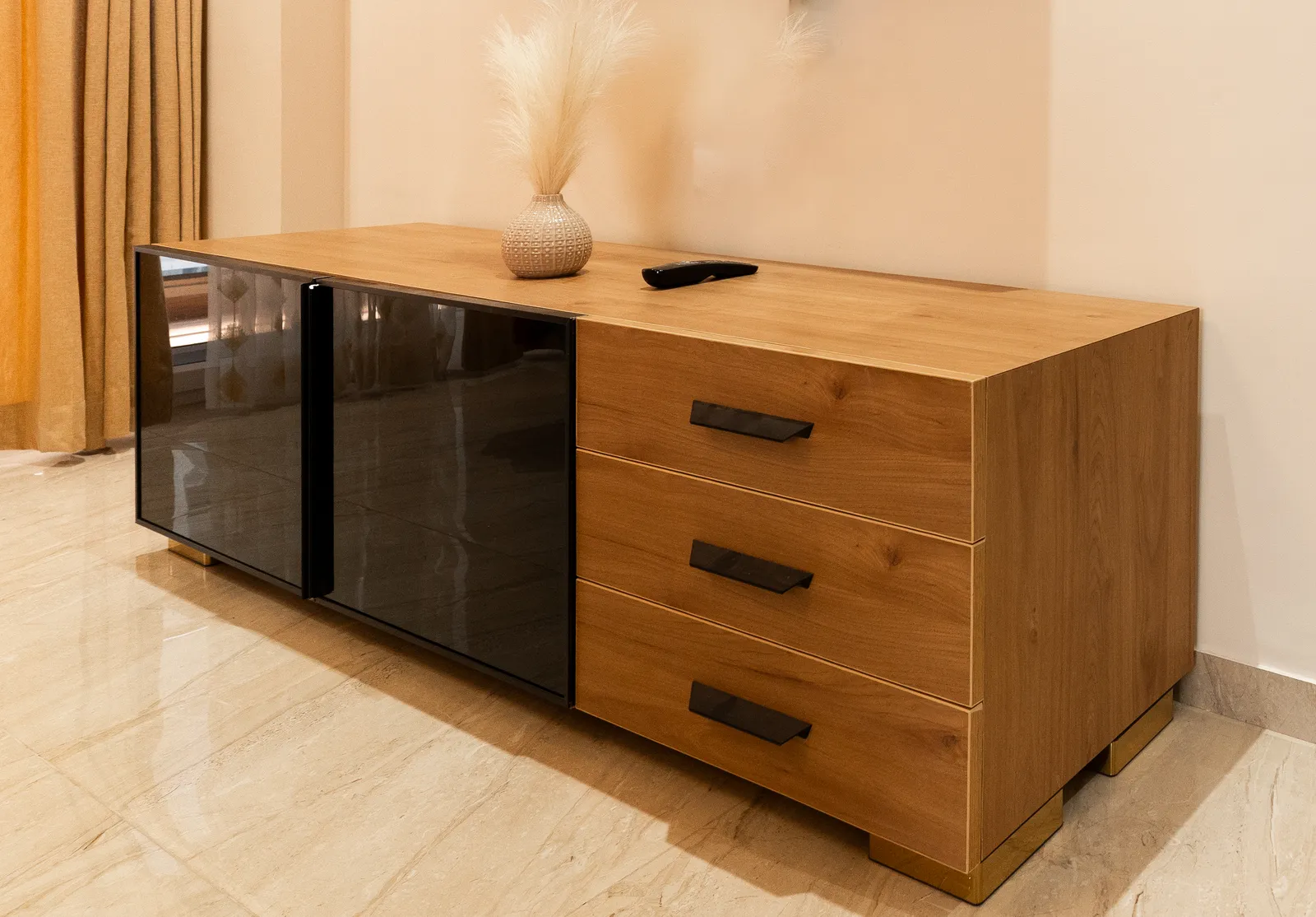 Oak-finish TV console with drawers and tinted glass shutters — Arna's Home